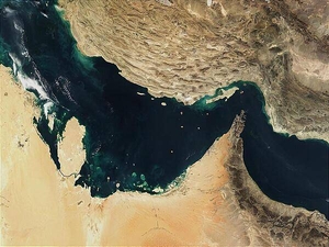 The Persian Gulf (left) and the Gulf of Oman (right) were once the site of a rift, an area where two plates of the earth's crust pulled apart from each other. The Indian Ocean filled in the widening gap between the two plates. Over time, the process reversed, and about 20 million years ago, the gulfs began to close up. The ongoing collision of the two continental plates resulted in Iran's mountainous terrain (top) and its periodic earthquakes. 

Several Gulf States are visible across the eastern Arabian Peninsula that makes up the lower part of the image. In addition to Saudi Arabia across the bottom, the islands of Bahrain in the left center lie next to the prominent peninsula that makes up Qatar. Further to the right are various offshore islands of the United Arab Emirates; most of the darker area to the right makes up Oman. Photo courtesy of NASA.