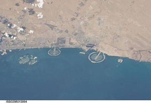 Three man-made archipelagos near Dubai, United Arab Emirates, are featured in this image from the International Space Station (ISS), flying at 350 km (220 mi) above Earth. The municipality of Dubai is the largest city of the Persian Gulf emirate of the same name, and has built a global reputation for large-scale developments and architectural works. Among the most visible of these developments - particularly from the perspective of astronauts onboard the ISS - are three man-made archipelagos. The two Palm Islands - Palm Jumeirah to the left of center, and Palm Jebel Ali, just to the right of center, appear as stylized palm trees when viewed from above. The World Islands (near left edge) evoke a rough map of the world from an air- or space-borne perspective. Image courtesy of NASA.