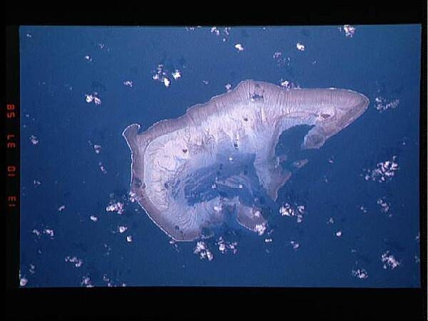 Ashmore Island (actually composed of three reef islets) is part of Ashmore Reef National Nature Reserve, established in August 1983, and covers 583 sq km (225 sq mi). It is of significant biodiversity value since it lies in the flow of the Indonesian Throughflow ocean current from the Pacific Ocean through the Malay archipelago to the Indian Ocean. It is also in a surface current west from the Arafura Sea and Timor Sea.

The Reserve comprises several marine habitats, including seagrass meadows, intertidal sand flats, coral reef flats, and lagoons, and supports an important and diverse range of species, including 14 species of sea snakes, a population of dugong that may be genetically distinct, a diverse marine invertebrate fauna, and many endemic species, especially of sea snakes and molluscs. There are feeding and nesting sites for various turtle species. It also serves as a bird sanctuary and has 50,000 breeding pairs of various kinds of seabirds. A high abundance and diversity of sea cucumbers, over-exploited on other reefs in the region, is present, with 45 species recorded. 

This astronaut photo from 1992 shows that the reef making up the island is not continuous but has several breaks that allow for current and sediment inflow. Image courtesy of NASA.