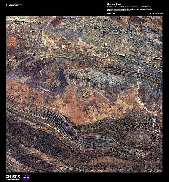 142 million years ago, an asteroid or comet slammed into what is now the Missionary Plains in the Northern Territory, forming a crater 24 km (15 mi) in diameter. Due to erosion, the crater rim has been reduced to only 5 km (3 mi). Today, like a bull's eye, the circular ring of hills that defines Gosses Bluff (image center) stands as a stark reminder of the event shown in this high-resolution satellite photo. Image courtesy of USGS.