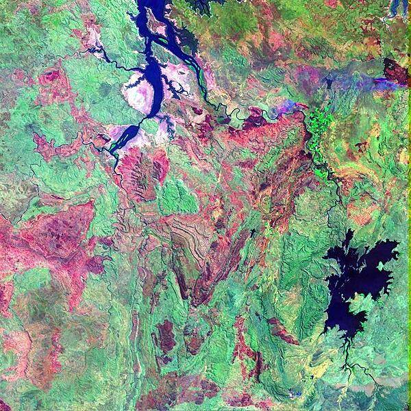 False-color satellite image shows a portion of the Kimberley Plateau, situated north of the Great Sandy Desert in a remote stretch of the province of Western Australia. In this scene, the Durack, Chamberlain, and Ord Rivers wind their way northward to the Joseph Bonaparte Gulf. The long elongated water bodies in the north are backwaters from the Timor Sea. The reddish brown patches are fire scars in the otherwise densely-vegetated (green) area. During the summer months, lightning strikes can quickly spark dozens of wildfires across Australia's Western and Northern Territories, giving the landscape its mottled appearance. Image courtesy of NASA.