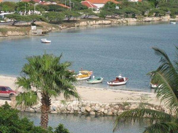 Small, colorful boats moored in a quiet harbor.