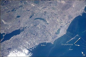 Baku is Azerbaijan's major city, and the oil capital of the Caspian region. This photo shows details of the city, including the extensive port facilities, and part of the large web of offshore oil platforms in the Caspian Sea. The oil platforms off Baku were built in the 1950s and 1960s, and were the first offshore oil-drilling efforts in the world. Today, multinational oil exploration, sea-level rise (the Caspian Sea has risen more than 2 m in the past 20 years), offshore platform maintenance, and environmental degradation are all hot topics in Baku. Image courtesy of NASA.