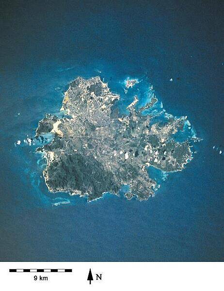 A closer view of the island of Antigua shows severely eroded volcanic remnants along its forested southwestern quadrant. Although Antigua receives approximately 100 cm (40 in) of precipitation annually, wide fluctuations in rainfall amounts occasionally create serious water shortages, especially for the agricultural industry. St. John's, the country's capital, is located along the northwest coast, adjacent to one of the island's many natural harbors. More than half of the country's population lives in the St. John's area. Image courtesy of NASA.