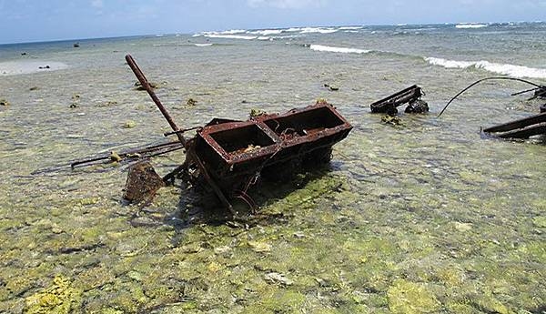 Wreckage scattered and pushed around the reef flat and rubble spit at Kingman Reef National Wildlife Refuge causes considerable damage and must be periodically removed. Image courtesy USFWS.