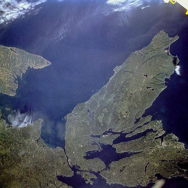The Canadian maritime province of Nova Scotia can be divided into two separate regions - Cape Breton Island (on the right) and much larger, peninsular mainland Nova Scotia (lower left). Cape Breton Island is joined to the mainland by a causeway and a railroad spanning the narrow Strait of Canso. St. George's Bay is the small bay west of the causeway, and the Northumberland Strait separates Cape Breton Island from the eastern end of Prince Edward Island, another maritime province of Canada (visible along the west margin of the photograph). Photo courtesy of NASA.