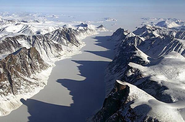 The image captures an ice covered fjord on Baffin Island with Davis Strait in the background. Image Credit: NASA/Michael Studinger.