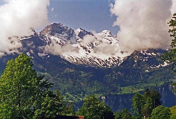 Towering peaks peer through some low-sailing clouds.