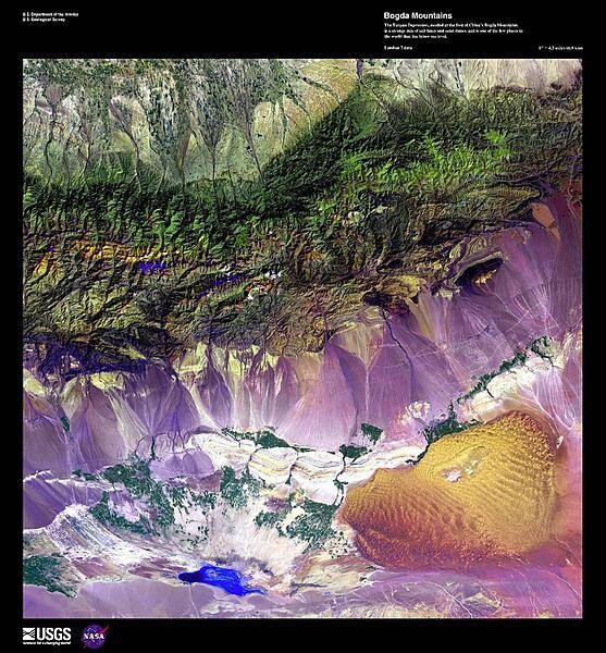 This false-color, high-resolution satellite photo shows the Turpan Depression, nestled at the foot of China's Bogda Mountains, south of the oasis city of Turpan. A strange mix of salt lakes and sand dunes, this fault-bounded trough is the lowest exposed surface in China. At the center of the basin lies Ayding Lake (bottom left), which is the third lowest exposed point on the earth's surface at -154 m (-505 ft). Image courtesy of USGS.