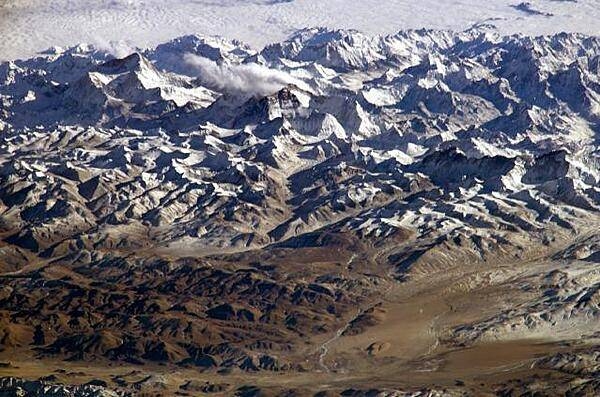 An oblique view of the Himalayas as seen from the International Space Station, 360 km (225 mi) up. The view looks south over the Tibetan Plateau and features Mt. Everest and Makalu (the 1st and 5th highest mountains in the world respectively). The image almost looks like a picture taken from an airplane until you remember that the summits of Makalu [left (8,462 m: 27,765 ft)] and Everest [center (8,850 m; 29,035 ft)] are at the heights typically flown by commercial aircraft, and could never be seen this way from an airplane. Click on photo for higher resolution. Image courtesy of NASA.