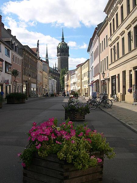 Looking down an old street in Wittenberg to the Schloss Kirche (Castle Church) where Luther nailed his 95 Theses in 1517 sparking the German Reformation. The church, completed in 1509, contains the tombs of Luther, Melanchton, and Frederick the Wise.