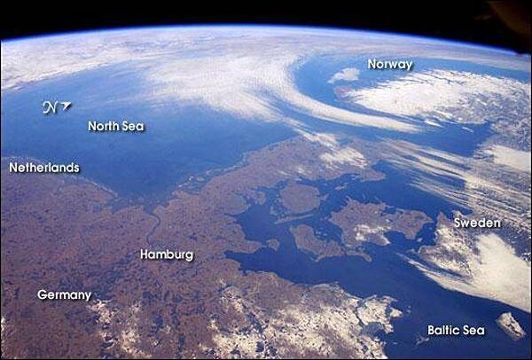 The Kingdom of Denmark consists of the Jutland Peninsula and roughly 500 islands. It is also a part of the generally fertile and mostly agricultural region known as the North European Plain. This entire region is generally flat to slightly rolling and is overlain with glacial deposits. This photo, taken from the International Space Station in late winter, shows little snow except for northeastern Germany, Sweden, and the rugged mountains of Norway. Image courtesy of NASA.
