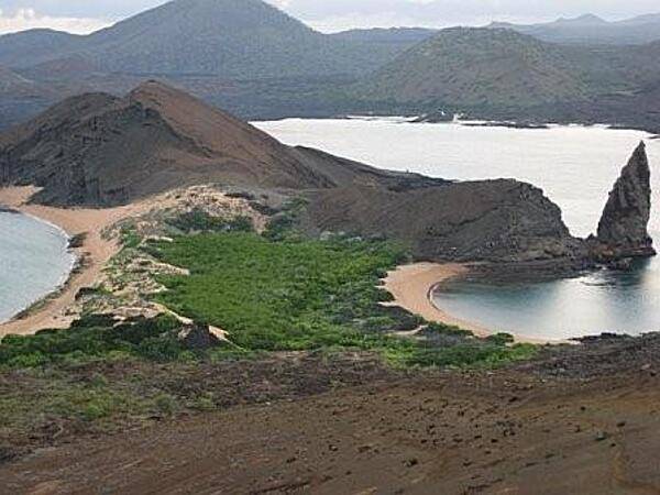 A beach view on the volcanic Galapagos Islands. In all there are 15 main islands, 3 smaller islands, and over 100 rocks and islets composing the archipelago, which is an Ecuadorian province, a national park, and a biological marine reserve.