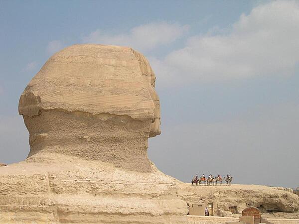 The immensity of the Sphinx becomes apparent when it is compared to a camel party riding along one of its paws.