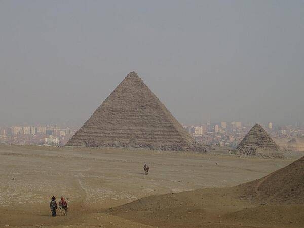 The Pyramid of Menkaure is the smallest of the three kings' pyramids on the Giza Plateau. The city of Cairo appears in the background.