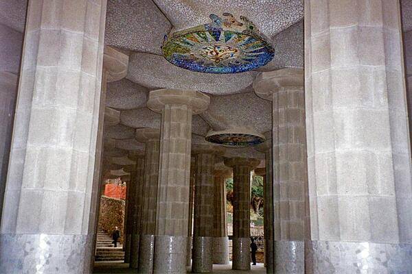 Doric columns supporting the roof of the lower court that forms the central terrace at the unique Park Guell garden complex in Barcelona. Designed by the Catalan architect Antoni Gaudi and built between 1910 and 1914, the park is full of his mosaics including this ceiling rondel.