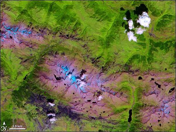The Alps may be more famous, but the Pyrenees have been around much longer - tens of millions of years longer, in fact. These mountains formed between 100 and 150 million years ago when the landmass that Spain occupies pushed into the one that France occupies. The mountains have served as a natural barrier between the Iberian Peninsula (Spain and Portugal) and the rest of Europe ever since. Stretching east to west across 430 sq km (166 sq mi), the Pyrenees fall mostly within Spain's borders, but also pass into the independent state of Andorra. The NASA Terra satellite captured this image of part of the Central Pyrenees - the highest part of the range - on 1 August 2000. In this false-color image, clouds appear white, snow appears pale blue, vegetation appears green, and bare ground appears as either pink or dark, bluish-purple. Water on the ground appears dark blue (or nearly black). In this shot, the vegetated areas are mostly to the north, and the peaks to the south are mostly bare rock. Patches of dark purple that are visible along rivers and in valley floors are probably developed areas. Image courtesy of NASA.
