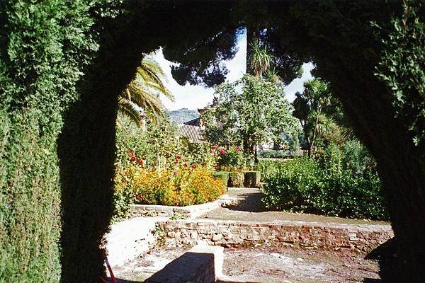 Alhambra garden viewed through an archway, Granada.