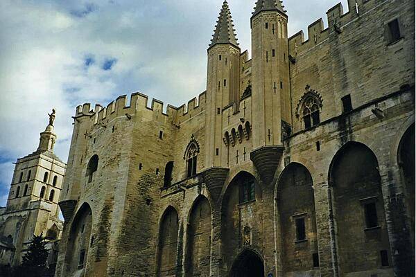 The city of Avignon in southeastern France is well known as the former seat of the papacy in the 14th century. Shown is the Palais des Papes (Palace of the Popes) on the right and the Romanesque Cathedral Notre Dames-des Doms on the far left.