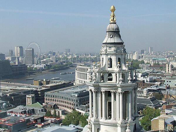 A vista of London from the Golden Gallery, the highest point of the outer dome of St. Paul's Cathedral in London. Some 85 m (280 ft) above the city, this view requires a climb of 530 steps. The large structure on the right is the cathedral's west end clock tower.