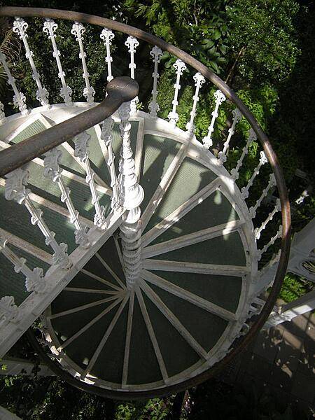 Spiral stairs in Kew Garden's Temperate House or Palm House, the largest Victorian glasshouse in the world. A walkway at a height of 9 m (30 ft) in the 19 m- (62 ft-) high nave allows visitors to look down upon the crowns of the palms. Kew Gardens is a UNESCO World Heritage site.