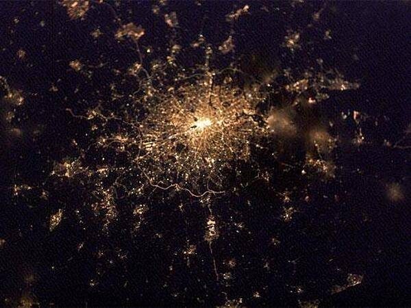 This intriguing "globular cluster of stars" is actually the "constellation" of city lights surrounding London as recorded February 2003 from the International Space Station. The encircling "London Orbital" highway by-pass, the M25, is easiest to pick out south of the city. Even farther south are the lights of Gatwick airport and just inside the western (left hand) stretch of the Orbital is Heathrow. Image courtesy of NASA.