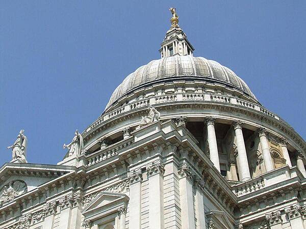 Looking up at the dome of St. Paul's Cathedral in London. This Anglican place of worship rests on Ludgate Hill, the highest point in the city. The present building - designed by Sir Christopher Wren - dates to the 17th century and is generally considered to be the fifth St. Paul's erected on the site.