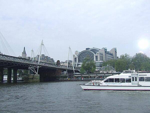 The Charing Cross Railroad Station in London. The Hungerford Bridge that leads to the station is flanked by two cable-stayed pedestrian bridges that share the railroad bridge's foundation piers and which are officially named the Golden Jubilee Bridges.