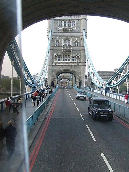 View from out the back of one of London's famous double-decker buses crossing Tower Bridge.