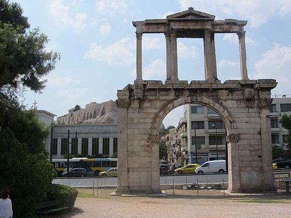Hadrian's Arch in downtown Athens was built in A.D. 131 or 132 to honor the Roman Emperor Hadrian, possibly for restoring much of the city and completing the nearby Temple of Olympian Zeus. The Parthenon and Acropolis can be seen in the left background.