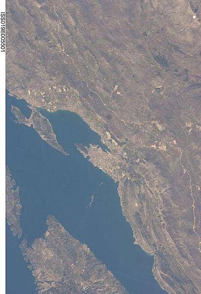 This view features the Dalmatian coastline of Croatia around the city of Split. Much of the region can be characterized by northwest-southeast oriented linear islands and embayments of the Adriatic Sea. This distinctive coastal geomorphology is the result of faulting caused by tectonic activity in the region and sea level rise. Photo courtesy of NASA.