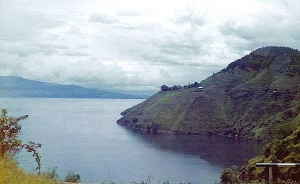 Lake Toba is located in the middle of the northern part of the island of Sumatra, occupying the caldera of a supervolcano. The lake is about 100 km (62 mi) long, 30 km (19 mi) wide, and up to 505 m (1,657 ft) deep. It is the largest lake in Indonesia and the largest volcanic lake in the world. 
Lake Toba is the site of a supervolcanic eruption estimated at a Volcanic Explosivity Index (VEI) of 8, the largest recorded value on the index. Recent advances in dating methods suggest the date was 74,000 years ago and that it represented a climate-changing event. It is the largest-known explosive eruption on earth in the last 25 million years.