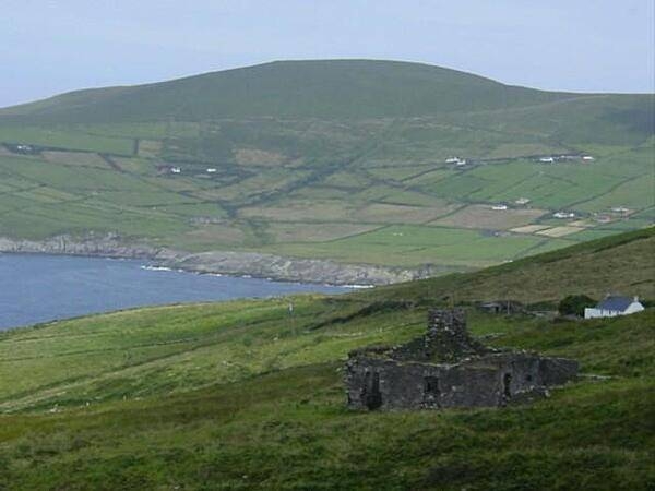 The ruins of an old farm house front a vista of patchwork Irish countryside.
