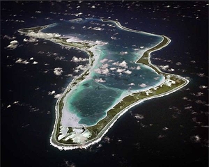 An aerial view of the island of Diego Garcia in the British Indian Ocean Territory. Diego Garcia is the location of an important UK and US air and naval base supporting operations throughout the Indian Ocean basin. The lagoon provides an excellent sheltered deep water anchorage. Photo courtesy of US Navy.