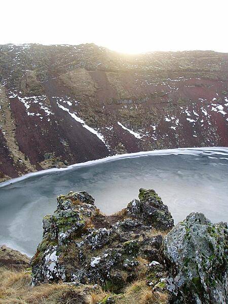 Sunset over a frozen lake-filled caldera.