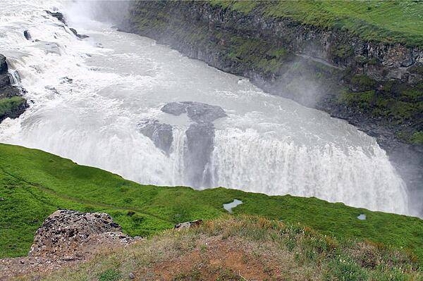 Mist rises above the Gullfoss Waterfall.