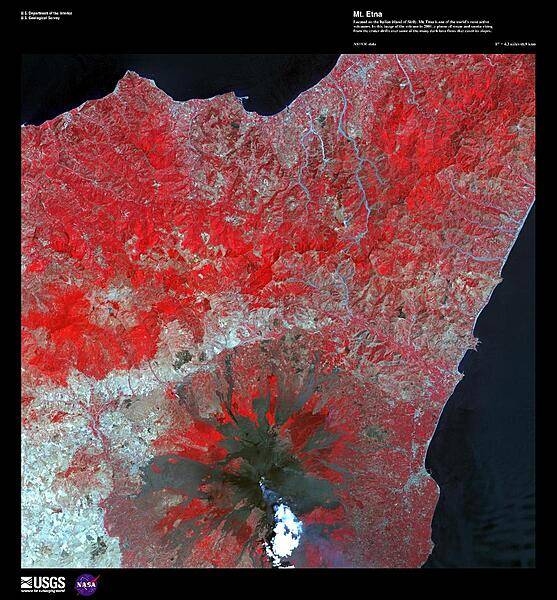 Located on the Italian island of Sicily, Mt. Etna is one of the world's most active volcanoes. In this false-color satellite image of the volcano in 2001, a plume of steam and smoke rising from the crater drifts over some of the many dark lava flows that cover its slopes. Due to summit eruptions, Mt. Etna's elevation of 3,329 m (10,922 ft) is 21 m (69 ft) lower than it was in 1981. Because of its recent activity and proximity to nearby population centers, it has been designated as a Decade Volcano by the International Association of Volcanology and Chemistry of the Earth's Interior. For other active volcanoes in Italy, see the Natural hazards-volcanism subfield in the Geography section. Image courtesy of USGS.