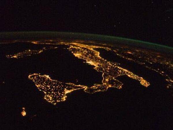 The "boot" of Italy is visible running diagonally southward from the horizon across the center of the frame, with the night lights of Rome and Naples being visible on the coast near the center. Sardinia and Corsica are just above left center of the photo, and Sicily is at lower left. The Adriatic Sea is on the other side of Italy, and beyond it to the east and north can be seen parts of several other European nations. Image courtesy of NASA.