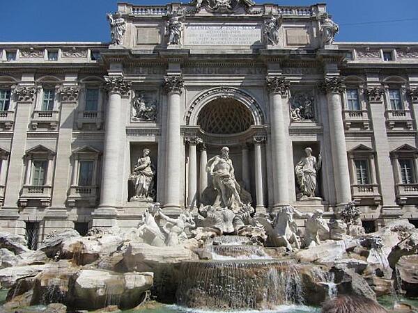 The Trevi Fountain in Rome. The baroque fountain was designed by Nicola Salvi in 1732. It depicts Neptune's chariot being led by Tritons with sea horses - one wild and one docile - representing the various moods of the sea.