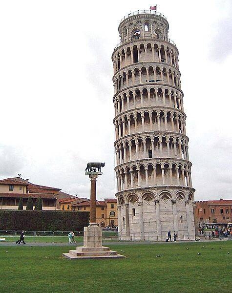 The famous Leaning Tower at Pisa. A statue of the legendary founders of Rome, Romulus and Remus, being suckled by a she-wolf appears in the foreground.