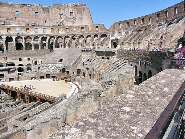 The Roman Colosseum's arena was a wooden floor covered with sand, underlain with rooms and passageways for performers, sets, and animals. Spectator seating was divided into three sections: ordinary people sat in the upper level, the better off in the middle sections, and the elite in the lower level.