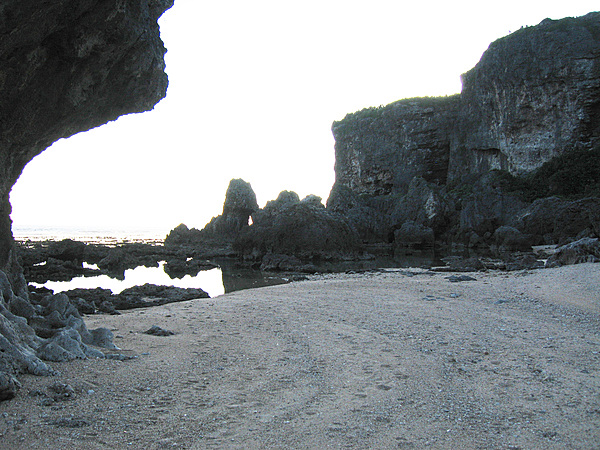 Rocky beach and rugged cliffs along an Okinawan sea shore.