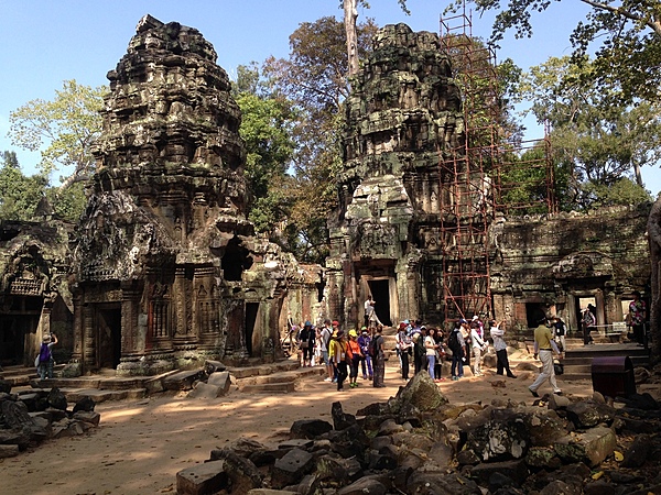 Ta Prohm is the modern name of the temple in Siem Reap, built largely in the late 12th and early 13th centuries. Located approximately 1 km east of Angkor Thom, it was founded by the Khmer King Jayavarman VII as a Buddhist monastery and university. Unlike most Angkorian temples, Ta Prohm remains in much the same condition as when it was found. The photogenic and atmospheric combination of trees growing out of the ruins and the jungle surroundings have made it one of Angkor's most popular temples with visitors. UNESCO inscribed Ta Prohm on its World Heritage List in 1992. Today, it is one of the most visited complexes in Cambodia’s Angkor region.