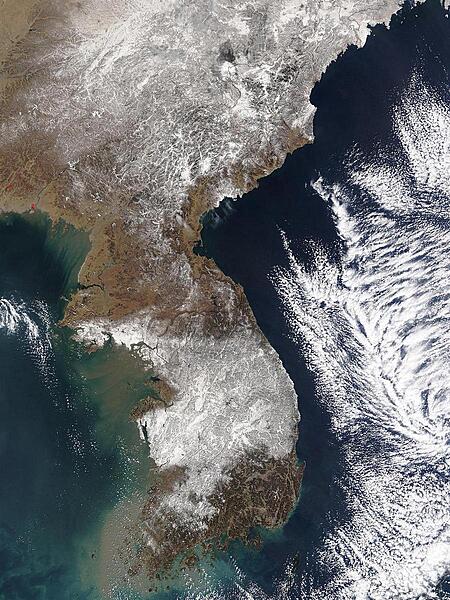 The central provinces of South Korea were crippled when heavy snow closed roads throughout the region, including many in the country's capital, Seoul. More snow fell on 6 March 2004, than ever recorded for a single March day in Korea since record keeping began in 1904. According to news reports, the city of Taejon received 49 cm (19 in) of snow on Friday, with an additional 15 cm (6 in) forecast for Saturday. The image shows the storm moving away from the peninsula on 7 March 2004, leaving much of South Korea under a blanket of snow. Image courtesy of NASA.