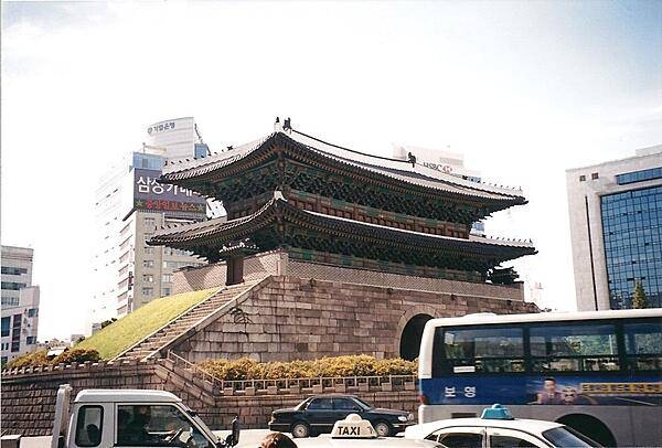 Namdaemun (Sungnyemun) in Seoul was the "Great Southern Gate" in the walls that once surrounded the city. This view was taken before the wooden upper portion was destroyed in a 2008 fire and subsequently restored.