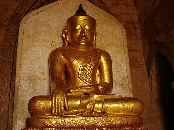 A golden Buddha statue sits in one of Bagan's many pagodas.