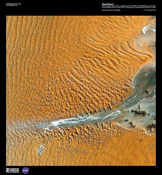 Namib-Naukluft National Park is an ecological preserve - the largest game reserve in Africa - in the vast Namib Desert, a part of which may be seen in this high-resolution satellite image. Due to the orange color of the sand, which develops over time as the iron in the sand is oxidized, the Namib Desert is considered the oldest desert in the world. Coastal winds create the tallest sand dunes in the world here, with some dunes reaching 300 m (980 ft) in height. Image courtesy of USGS.