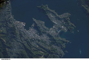 A view of New Zealand's capital of Wellington, located at the southwestern tip of North Island near the Cook Strait. The city is the second largest in New Zealand (after Auckland), and at 41 degrees south latitude, it is the southernmost capital city in the world. Five major geologic faults run through the Wellington municipality. Recognition of the potential seismic hazard in the metropolitan area has led to the adoption of building codes to maximize structural resistance to earthquake damage. Click on photo to increase resolution. Image courtesy of NASA.