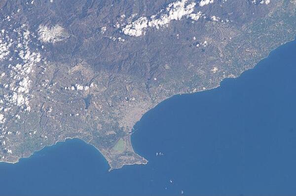 The Sovereign Base Area of Akrotiri juts into the Mediterranean Sea in this astronaut photo from 2003. The salt lake appears green in this image; the gray area further north is the Cypriot city of Limassol. Image courtesy of NASA.