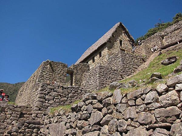 A house at the Machu Picchu ruins with a new thatched roof, modeled after the Inca roof design.
